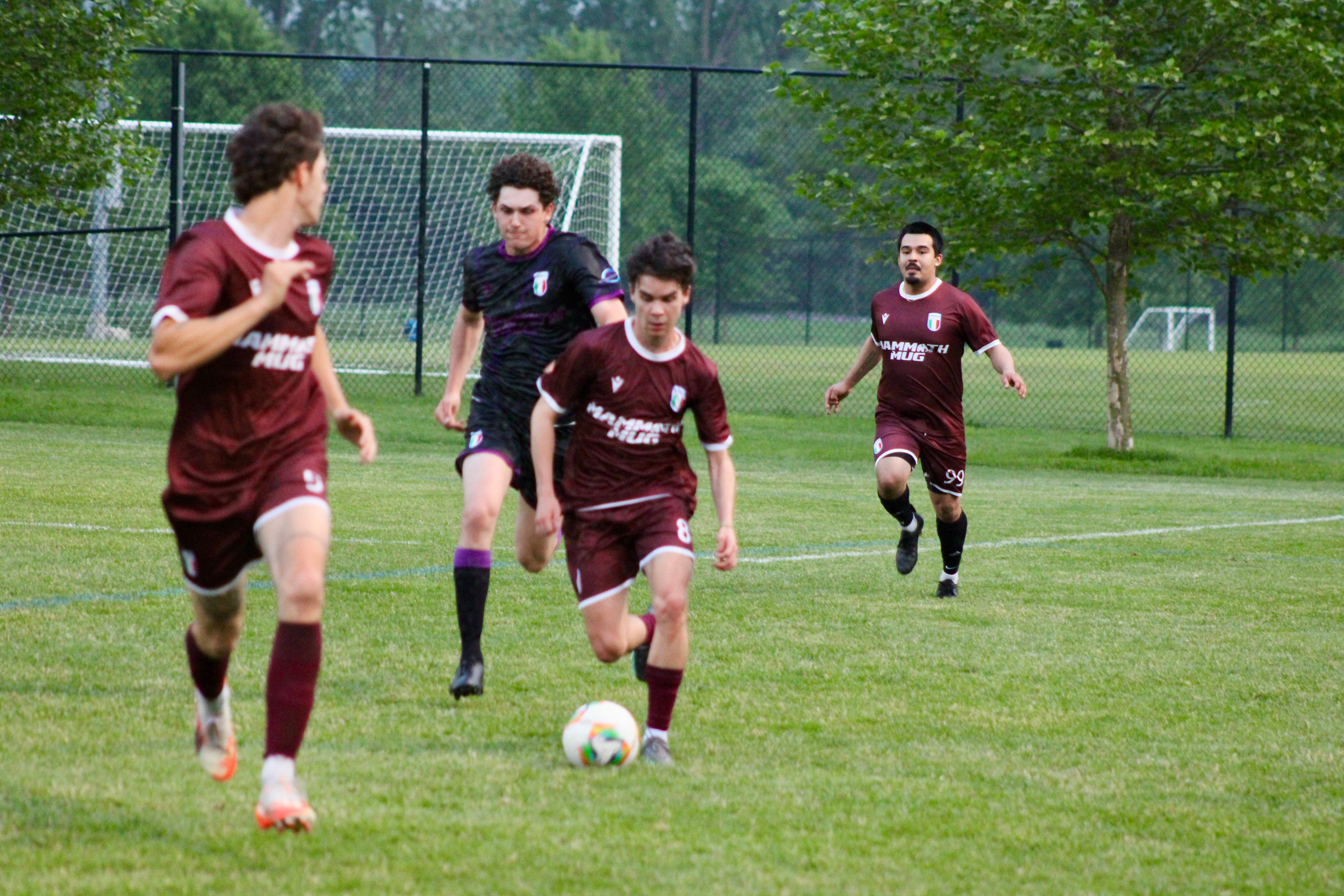 Multiple Buringa FC players during coordinated team play in outdoor match