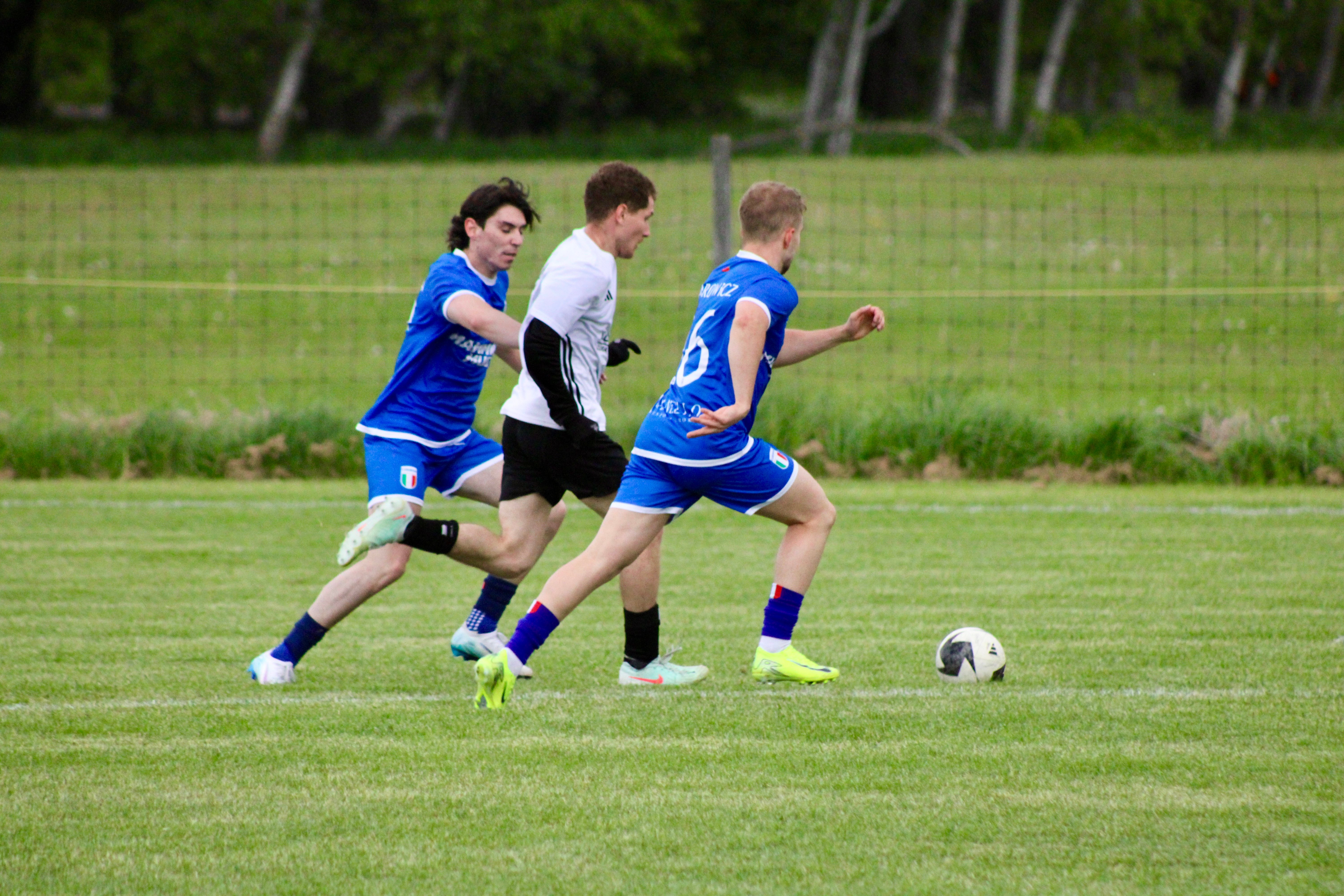 Curinga FC players including Starowicz (#16) competing for the ball