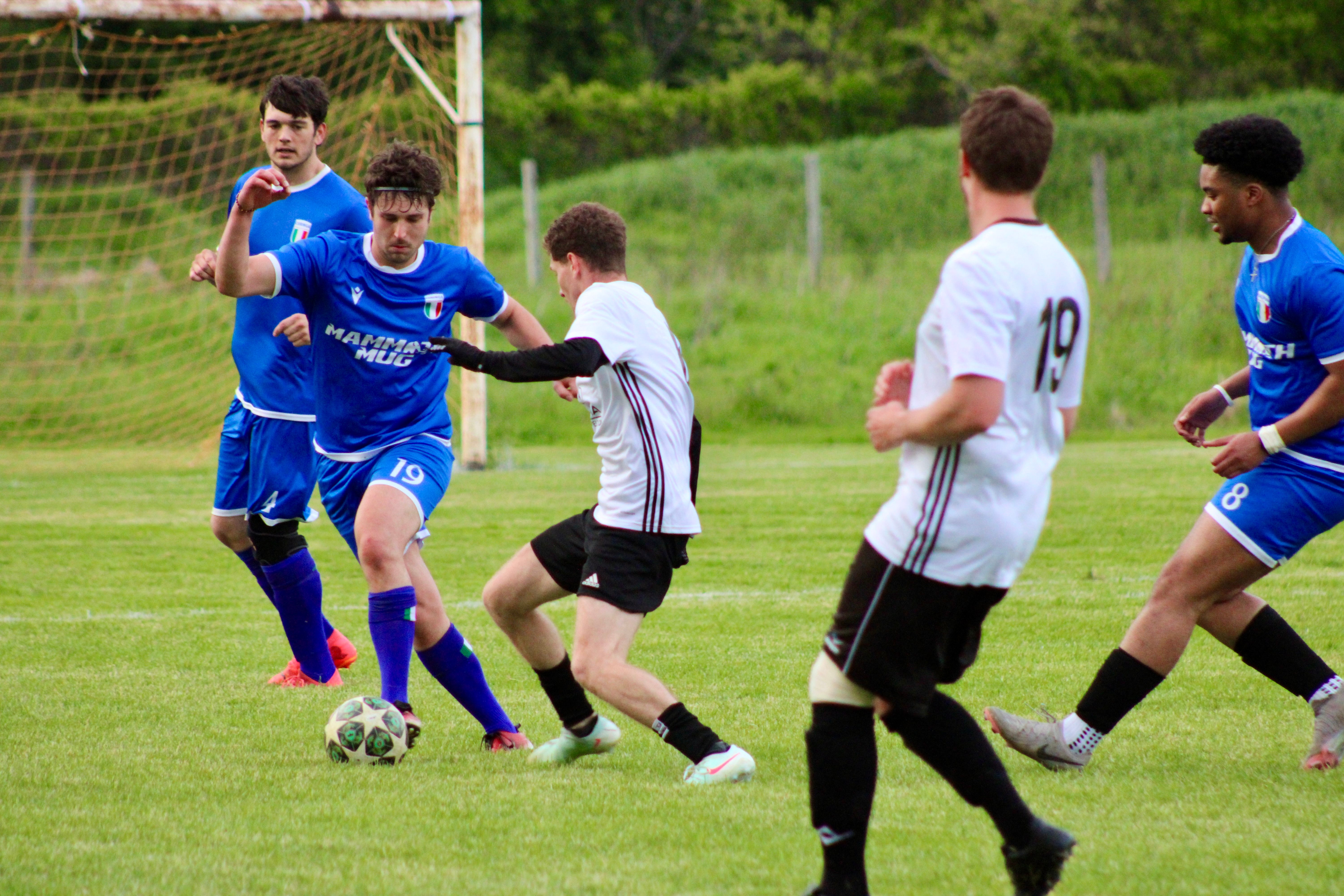 Multiple Curinga FC players including Paino (#19) and Okoronkwo (#8) in action