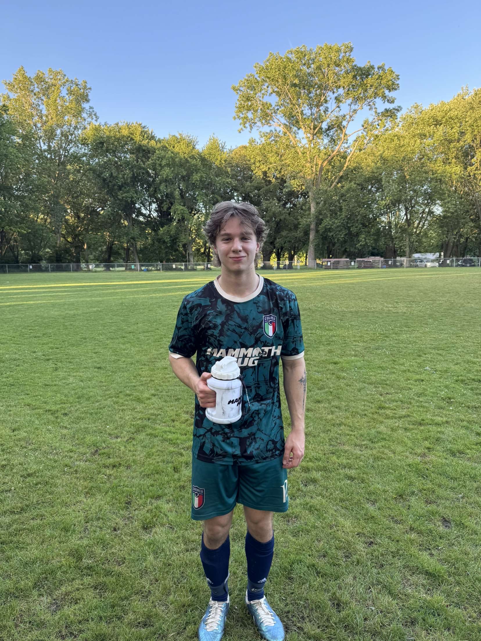 Curinga FC player posing with water bottle after match
