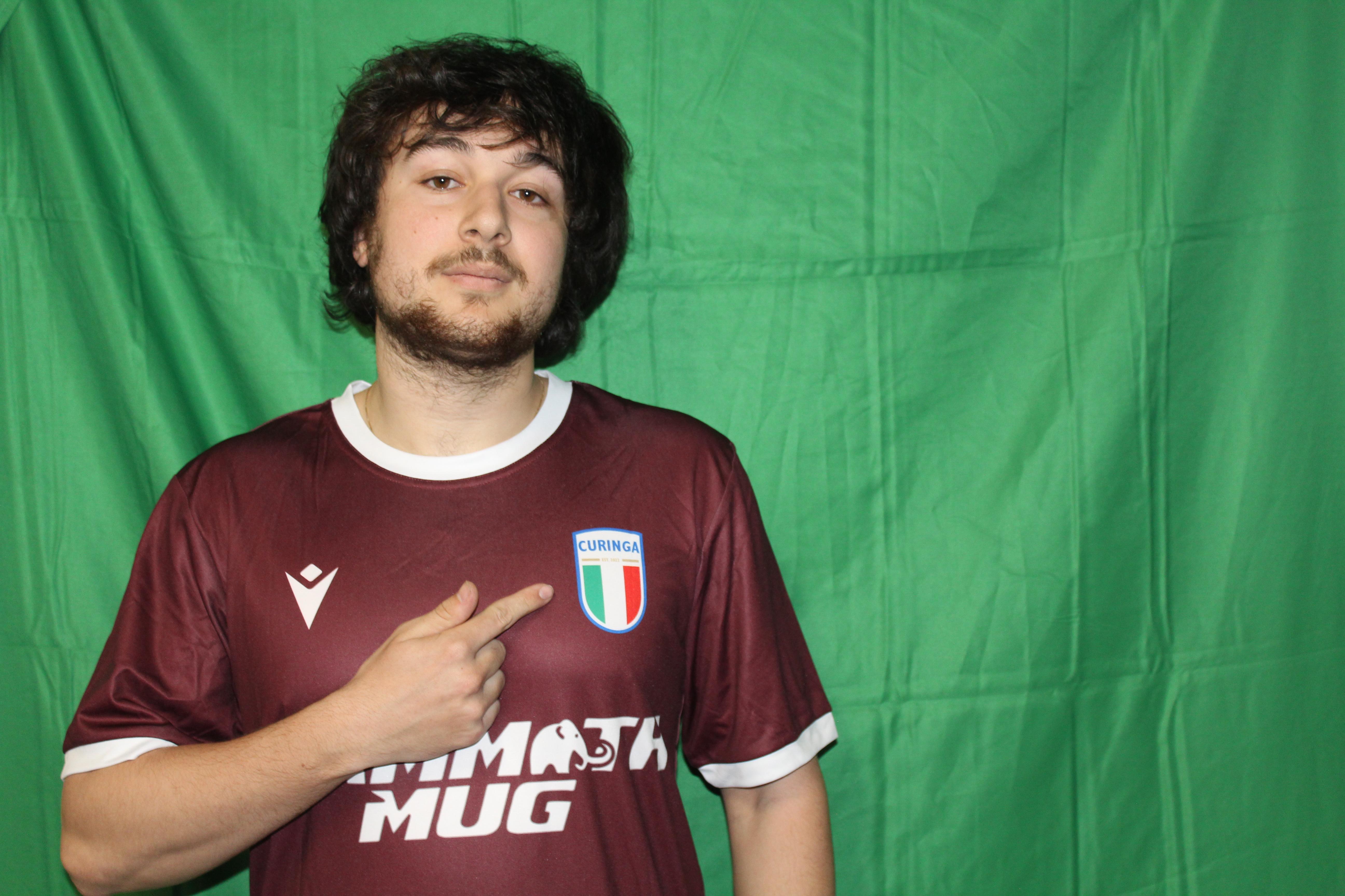 Buringa FC player smiling in maroon jersey