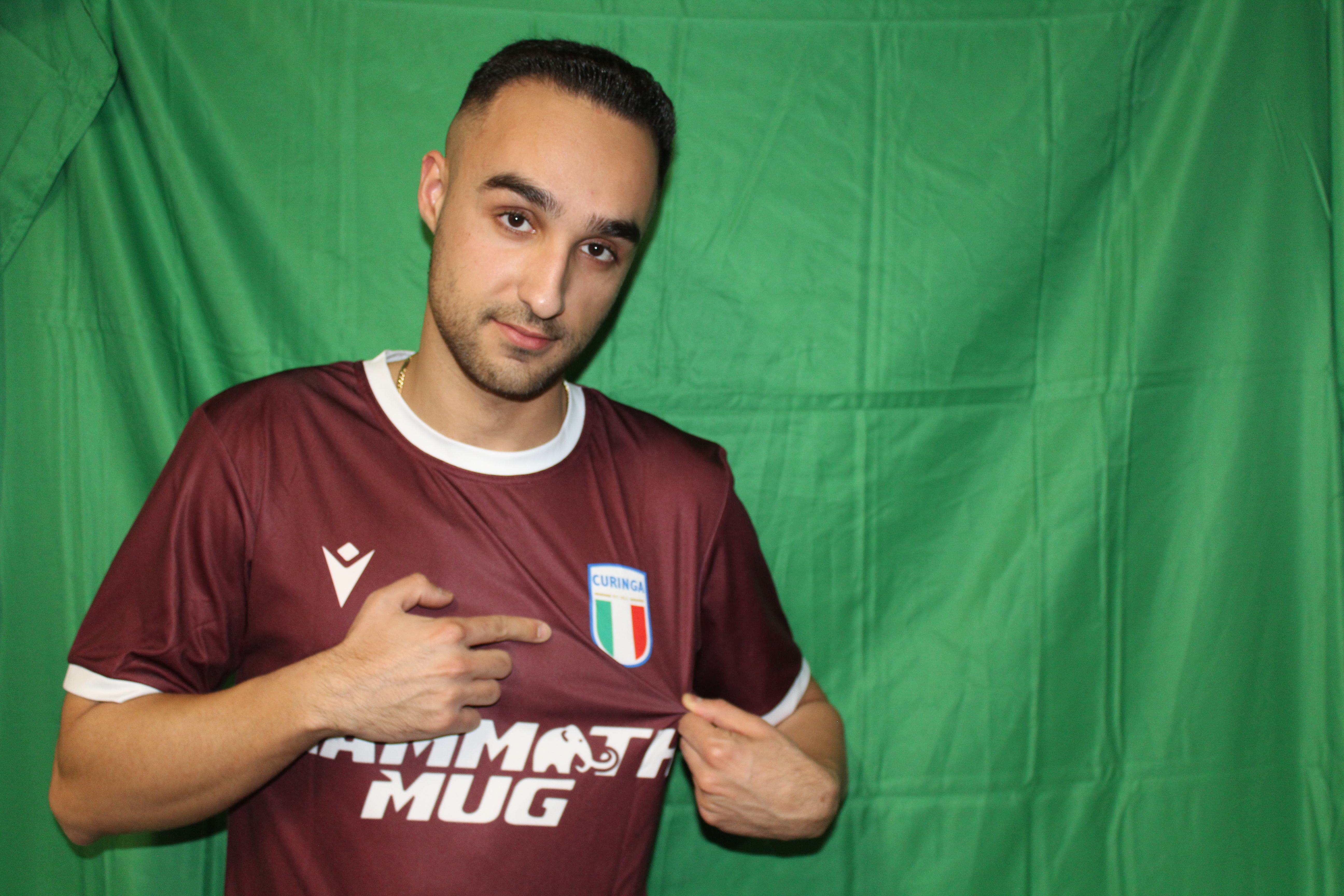 Buringa FC player pointing to team crest on jersey